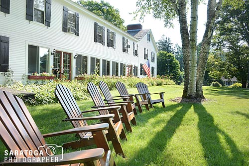 Adirondack Chairs In Front Of Old Inn
