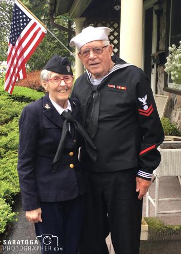 Portrait of greatest generation 80-year-old man and woman navy veterans