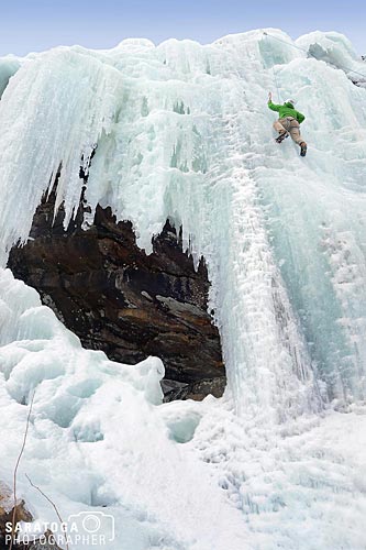Ice Climber Scalling Frozen Wall