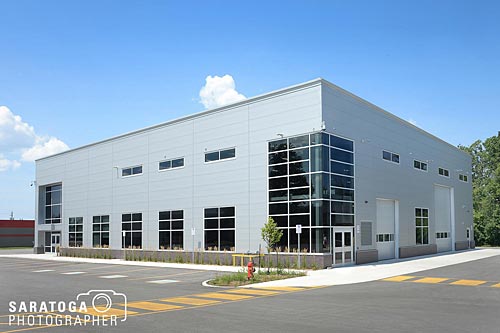 Exterior view of industrial garage made with silver steel siding and modern architectural glass
