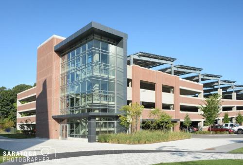 Extreipr daytime parking garage structure including stairwell an solar panel roof in watertowm massecusets