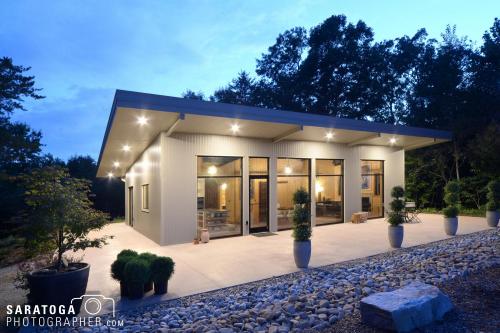 Dusk photo of modular home and patio lit from the inside at over mountain winery resort