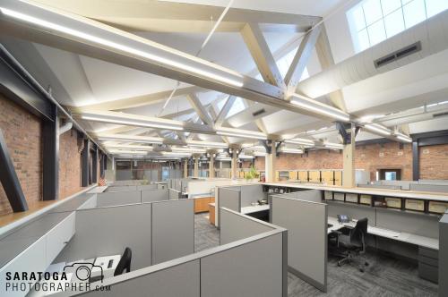 Cubicle office spaces in renovated 18th century mill showing overhead beams